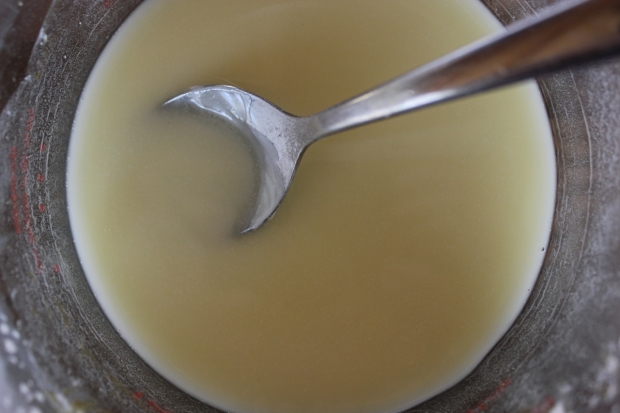 Once the coconut oil and beeswax have melted, remove from heat and add in all other ingredients, stirring the mixture.